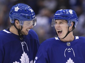 Maple Leafs right wing Mitchell Marner (right) and centre Auston Matthews (left) laugh after Marner scored a goal against the Panthers during third period NHL action in Toronto on Thursday, Dec. 20, 2018.