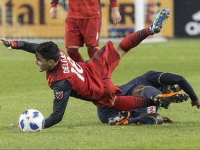 Philadelphia Union's C.J. Sapong (right) fouls Toronto FC midfielder Marco Delgado during first half MLS action in Toronto on Friday May 4, 2018 .THE CANADIAN PRESS/Chris Young