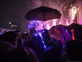 People watch the fireworks during the New Year's Eve celebrations held at Nathan Phillip square in Toronto just after midnight, Tuesday, Jan. 1, 2019. THE CANADIAN PRESS/ Tijana Martin ORG XMIT: TIJ110