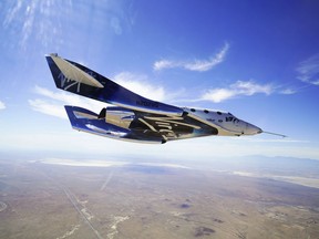 This May 29, 2018 photo provided by Virgin Galactic shows the VSS Unity craft during a supersonic flight test. The spaceship isn't launched from the ground but is carried beneath a special aircraft to an altitude around 50,000 feet (15,240 meters).