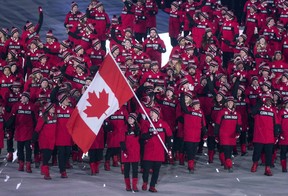 Canadian ice dance team Tessa Virtue and Scott Moir lead team Canada into the Olympic stadium as the flag bearers during the opening ceremonies at the 2018 Winter Olympic Games in Pyeongchang, South Korea, on Friday, Feb. 9, 2018.