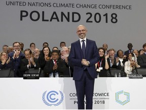 President Michal Kurtyka poses for a photo after adopting the final agreement during a closing session of the COP24 U.N. Climate Change Conference 2018 in Katowice, Poland, Saturday, Dec. 15, 2018.