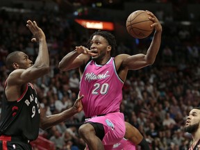 Miami Heat forward Justise Winslow (20) drives to the basket against Toronto Raptors forward Serge Ibaka (9) during the second half of an NBA basketball game Wednesday, Dec. 26, 2018, in Miami. Toronto defeated Miami 106-104. (AP Photo/Joel Auerbach) ORG XMIT: FLJA114