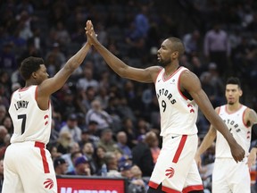 Toronto Raptors' Kyle Lowry, left, and Serge Ibaka give each other a high five during the second half of the Raptors 114-105 win over the Sacramento Kings in a NBA basketball game Wednesday, Nov. 7, 2018, in Sacramento, Calif. (AP Photo/Rich Pedroncelli)