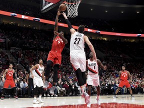Toronto Raptors forward Serge Ibaka, left, drives to the basket Portland Trail Blazers center Jusuf Nurkic, right, during the first half of an NBA basketball game in Portland, Ore., Friday, Dec. 14, 2018. (AP Photo/Steve Dykes) ORG XMIT: ORSD102