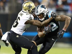 Panthers' D.J. Moore (12) is tackled by Saints' P.J. Williams (26) during first half NFL action in Charlotte, N.C., Monday, Dec. 17, 2018.