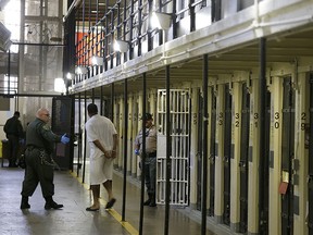 In this Aug. 16, 2016 file photo, a condemned inmate is led out of his east block cell on death row at San Quentin State Prison in San Quentin, Calif. (AP Photo/Eric Risberg, file)
