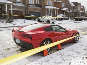 A red car remains cordoned off by police tape and evidence markers on Barnwood Dr., in the Bayview Ave. and Old Colony Rd. area of Richmond Hill, Ont.  on Tuesday December 25, 2018.