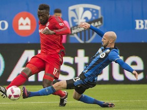 Montreal Impact's Laurent Ciman, right, challenges Toronto FC's Jozy Altidore during first half MLS soccer action in Montreal, Sunday, October 16, 2016. THE CANADIAN PRESS/Graham Hughes