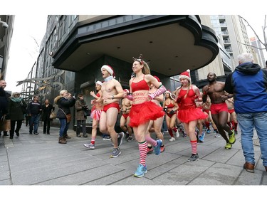 Around 50 runners make their way around Yorkville during the 11th annual Toronto Speedo Run on Saturday December 15, 2018. Clad in nothing but running shoes and Speedo bathing suits, entrants braved the cold to raise money for the Toys and Games Fund at Toronto Hospital for Sick Children.  Dave Abel/Toronto Sun/Postmedia Network
