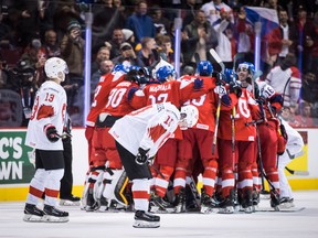Switzerland’s Justin Sigrist (left) and Yannick Bruschweiler look on in disbelief as Czech Republic players celebrate their overtime win during at the world junior championship in Vancouver on Wednesday. The Swiss face off against Team Canada on Thursday.  (Darryl Dyck /The Canadian Press)