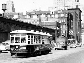 This photograph, taken c1952 by an unknown photographer, looks east on Front St. from a location just east of John St. The Barclay Hotel, which was at the northeast corner of Front and Simcoe Sts., is seen looming over the truck and the car following in the right background. Westbound on Front is the TTC's "small" Peter Witt streetcar #2862 operating on the Bathurst "tripper" route where the term "tripper" was used to describe a special routing operated only during rush hours. In this case, the Bathurst "tripper" operated between the loop at Bathurst and Vaughan (south of St. Clair Ave. W.) via Bathurst, along Front returning after looping at Scott St. Also seen in the view are the Canadian Pacific Railway's freight sheds that were located where Simcoe Park is today.