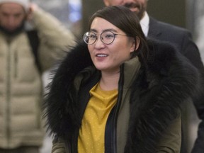 Law student and escort Nadia Guo leaves for a lunch break with her lawyer Kris Borg - Olivier, after appearing before a hearing of the Law Society, on Thursday December 13, 2018. (Stan Behal/Toronto Sun)