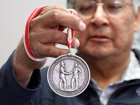 Chief Clifford Bull of the Lac Seul First Nation shows the 1873 treaty medal handed down for decades from chief to chief at the band office in Frenchman's Head, Ont., on Tuesday, April 24, 2018. THE CANADIAN PRESS/Colin Perkel