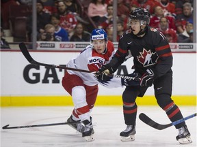 Without his stick Czech Republic's Ondrej Machala defends against Team Canada's Nick Suzuki in the second period of a 2019 IIHF World Junior Championship hockey game at Rogers Arena in Vancouver,  Dec. 29, 2018. (Gerry Kahrmann/Postmedia Network)