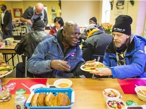 Moses (left) and Gordon during a Christmas meal at the Scott Mission in Toronto, Ont. on Tuesday December 25, 2018.