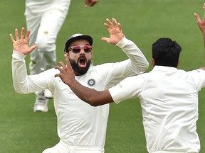 India’s Virat Kohli (left) celebrates with Ravichandran Ashwin after beating Australia on day five of the first Test cricket match at the Adelaide Oval this week.  Getty Images