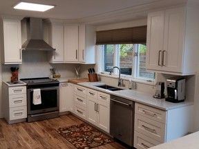 AFTER: The wish list included solid wood, white, Shaker-style cabinets, marble-look quartz countertops and new appliances.