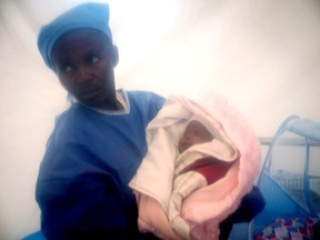 In this photograph taken last Dec. 3, 2018 and released by UNICEF, an Ebola survivor cares for one week-old Benedicte who was infected at birth with the Ebola virus by her mother, at an Ebola treatment centre in Beni, Democratic Republic of the Congo.