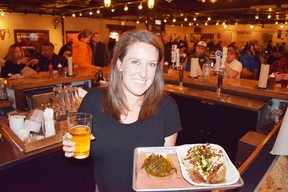 Bartender Brittany Newman brought us beer and Hot Mess (shredded brisket atop a sweet baked potato) at Dallas’ top barbecue restaurant Pecan Lodge. (Steve MacNaull)