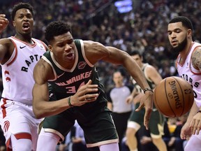 Milwaukee Bucks forward Giannis Antetokounmpo (34) chases a loose ball as Toronto Raptors guard Kyle Lowry (7) and Toronto Raptors guard Fred VanVleet (23) look on during first half NBA basketball action in Toronto on Sunday, Dec. 9, 2018. THE CANADIAN PRESS/Frank Gunn