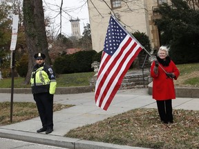 People line the streets to pay their respects as the hearse with the casket of former President George H.W. Bush passes by from the Capitol on the way to a State Funeral at the National Cathedral, Wednesday, Dec. 5, 2018, in Washington.