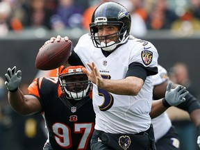 In this Sunday, Jan. 1, 2017 file photo, Baltimore Ravens quarterback Joe Flacco looks to pass under pressure from Cincinnati Bengals defensive tackle Geno Atkins in the first half of an NFL game in Cincinnati.