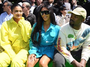 Kylie Jenner, left, Kim Kardashian, middle, and Kanye West attend the Louis Vuitton Menswear Spring/Summer 2019 show as part of Paris Fashion Week on June 21, 2018 in Paris.  (Pascal Le Segretain/Getty Images)