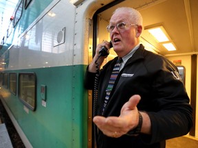 GO Train conductor Gord Plumridge, sings on the Barrie-bound Go Train at Union Station in Toronto, Ont. on Friday December 21, 2018. (Dave Abel/Toronto Sun/Postmedia Network)
