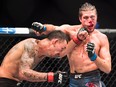 Max Holloway, left, fights Brian Ortega during the UFC featherweight championship title bout in Toronto on Sunday, Dec. 9, 2018.