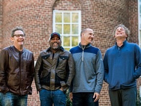 In this Nov. 16, 2018 photo, Dean Felber, from left, Darius Rucker, Jim Sonefeld, and Mark Bryan, of Hootie & the Blowfish, pose for a portrait at the University of South Carolina in Columbia, S.C. The band is returning with a tour and album 25 years after “Cracked Rear View” launched the South Carolina-based rock band. (Sean Rayford/Invision/AP)