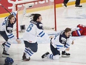 Finland’s Vili Saarijarvi, left, Joni Tuulola and Kasperi Kapanen, right, celebrates winning the world championship after the 2016 IIHF World Junior Ice Hockey Championship final against Russia in Helsinki, Finland, Tuesday Jan. 5, 2016.