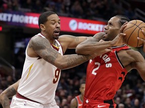 The Raptors' Kawhi Leonard (right) drives past the Cavaliers' Channing Frye during the second half in Cleveland last night. (Tony Dejak/The Associated Press)