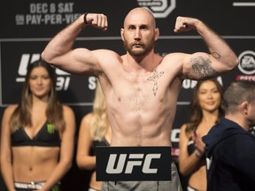 Canadian UFC fighter Kyle Nelson poses on the scale ahead of his bout against Diego Ferreira at UFC 231 in Toronto on Friday, Dec. 7, 2018. (THE CANADIAN PRESS/Chris Young)