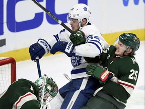 Wild defenceman Jonas Brodin rides Auston Matthews into the side of the net on Saturday night, allowing goalie Devan Dubnyk to make the save. Mike Babcock said he’d love for the Leafs to play the tough, disciplined Wild 20 times to preprare for the playoffs.    Hannah Foslien/ap