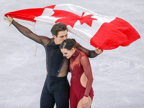 Tessa Virtue and Scott Moir celebrate their gold medal win in the ice dance free program at the 2018 Olympic Winter Games in Pyeongchang, South Korea, on Tuesday, Feb. 20, 2018.