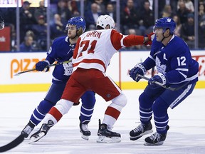 Toronto Maple Leafs William Nylander and teammate Patrick Marleau  try to sandwich Detroit Red Wings Dylan Larkin during the first period in Toronto on Thursday, Dec. 6, 2018.