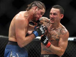 Max Holloway (R) of the United States fights against Brian Ortega of the United States in a featherweight bout during the UFC 231 event at Scotiabank Arena on Dec. 8, 2018 in Toronto.