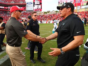 Head coach Dirk Koetter of the Tampa Bay Buccaneers and Ron Rivera of the Carolina Panthers shake hands after the Buccaneers won 24-17 at Raymond James Stadium on December 2, 2018 in Tampa, Florida. (Will Vragovic/Getty Images)