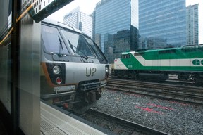 A Union-Pearson Express train waits at Toronto’s Union Station as a GO Train passes on Friday, Dec. 21 2018. (Bryan Passifiume/Postmedia Network)