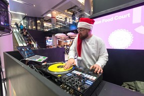 DJ James Redi spins tunes for diners in the Union Station food court on Friday, Dec. 21. (Bryan Passifiume/Toronto Sun)