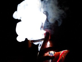 A woman smokes a marijuana cigarette in Toronto, Ontario, Canada, on Wednesday, Oct. 26, 2011. (Brent Lewin/Bloomberg)