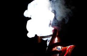 A woman smokes a marijuana cigarette in Toronto, Ontario, Canada, on Wednesday, Oct. 26, 2011. (Brent Lewin/Bloomberg)