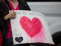 A counter-protestor holds a sign during the Unite the Right 2 Rally in Washington, DC on August 12, 2018. Last year's protests in Charlottesville, Virginia, that left one person dead and dozens injured, saw hundreds of neo-Nazi sympathizers, accompanied by rifle-carrying men, yelling white nationalist slogans and wielding flaming torches in scenes eerily reminiscent of racist rallies held in America's South before the Civil Rights movement. (ZACH GIBSON/AFP/Getty Images)