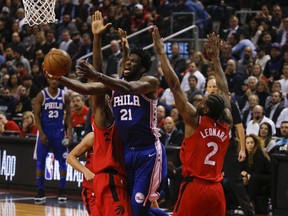 Philadelphia 76ers Joel Embiid C (21) is guarded by Toronto Raptors Kawhi Leonard SF (2) during the second quarter in Toronto, Ont. on Thursday December 6, 2018. Jack Boland/Toronto Sun/Postmedia Network