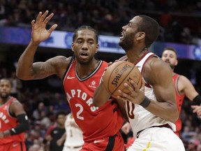 Cleveland Cavaliers' Alec Burks, right, drives against Toronto Raptors' Kawhi Leonard in the first half of an NBA basketball game, Saturday, Dec. 1, 2018, in Cleveland. (AP Photo/Tony Dejak) ORG XMIT: OHTD105