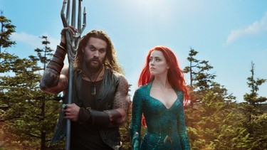 Jason Momoa and Amber Heard in a scene from "Aquaman." (Warner Bros.)