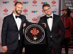 Seth Rogen, right, and Evan Goldberg stand by their star as they are inducted into the 2018 Canada Walk of Fame during a press red carpet event in Toronto on Saturday Dec. 1, 2018.