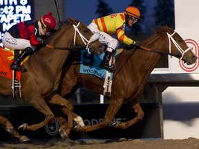 Pumpkin Rumble (right), ridden by Eurico Da Silva, gets to the finish line ahead of Melmich, ridden by Luis Contreras, to win the Grade 3 Valedictory Stakes on Dec. 9, 2018, at Woodbine. (WEG/MICHAEL BURNS photo)