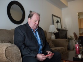 Rick Brown sits in his living room with a small Bible in Kitchener Ont. on Feb.8, 2018. In October 1963, a judge ordered Brown to Brookside, the reform school in Cobourg. The only paper record he still has of his stay there is the Bible they gave him that first day of his year in hell, as he puts it. THE CANADIAN PRESS/Hannah Yoon